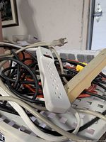 White 6-outlet power strip, beige power strip, assorted cords