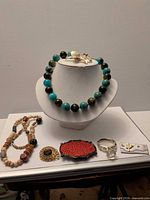 All jewellery items displayed on bust and table