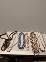 All six necklaces laid out side by side