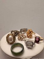 All eight costume rings displayed on white stand