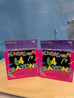 Front view of two sealed KidsKraft 64-count crayon boxes