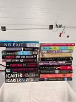 Two stacks of paperback books showing all titles in lot