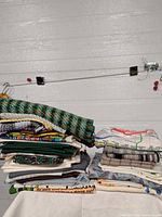 Full view of two stacks of assorted linens on table
