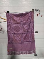 Full view of folded shawl hanging