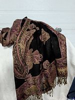 Overall view of shawl draped, showing pattern and fringes