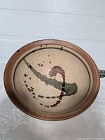 Top view shows interior abstract glaze pattern and overall shape