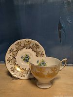 Cup and saucer front view showing pattern and gold detailing