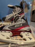 Side view of Bauer Vapor skates showing boot, TUUK holder and runners