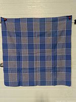 Full view of square tablecloth hung against wall