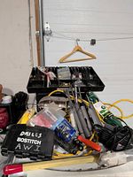 Lot overview showing organizer, cords, Bostitch case and tools