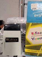 Halina Ambassador slide viewer beside its original box