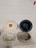 Four ashtrays grouped on table