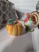 Turkey and pumpkin ceramic shakers side by side