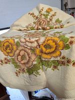 Overall view of cream towel showing yellow and brown floral bouquet pattern