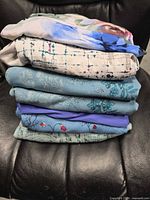 Stack of six folded tops showing prints and colors