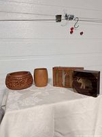 Group shot of four vintage wood decor items: carved bowl, cylindrical cup, rectangular tree-inlay box, square elephant-inlay box