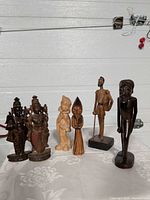 Group shot of all six wood figurines side by side
