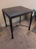 Full view of accent table showing metal frame and stretcher