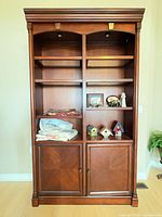 Front view of full cabinet showing shelves, cupboard doors, lighting
