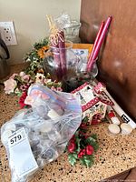 Countertop view showing assorted candles, vases, faux florals