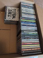 Open box showing full stack of jewel case CDs