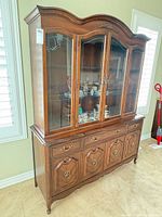 Front view showing full cabinet, glass doors, drawers, cupboards