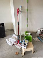All items grouped: spin mop bucket, Vileda spray mop, flat mop, rags, stool, spare heads visible