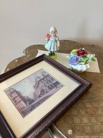 Full lot showing framed print, girl figurine, porcelain floral bouquet