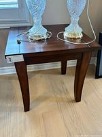 Full view of dark wood end table front and side