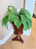 Full view faux fern in wood stand