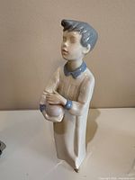 Front view of porcelain boy figurine