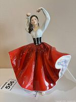 Front view of Royal Doulton Karen figurine showing red skirt and raised arms