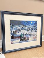 Full view of framed print showing blue frame and matting