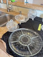 Group shot showing all glass and crystal pieces on black cloth