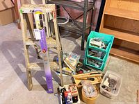 Full lot view with ladder, privacy film, paint supplies, drawer organizers, hardware bin