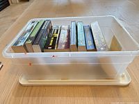 Side view of bin with visible stack of paperback novels