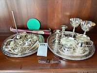 Full lot showing both serving trays, goblets, candlesticks, cream & sugar, candelabra parts and candles