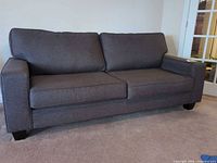 Front view of grey sofa showing cushions and legs