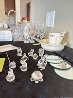 Group of Swarovski crystal figurines with mirrors and key on table