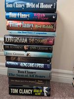 Full stack of 12 hardcover books showing spines