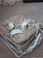 Folded tan electric blanket with controllers and storage bag