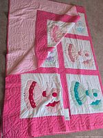 Full view of quilt front showing four blocks and quilting pattern