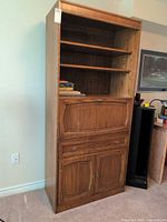 Full view of wall unit closed showing shelves, drawer, cabinet