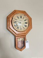 Full view of Bulova regulator wall clock on wall