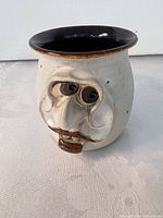 front view showing sculpted face, rim and interior color