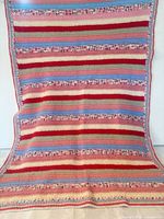 Full view showing entire crocheted striped throw blanket