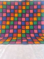 Full view of crocheted throw showing size and pattern