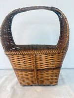 Front view of handwoven wicker basket with arched handle