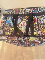 Front view of Ikea tote backpack showing multicolor graphics and black straps