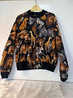 Front view of bomber jacket showing animal print and zipper